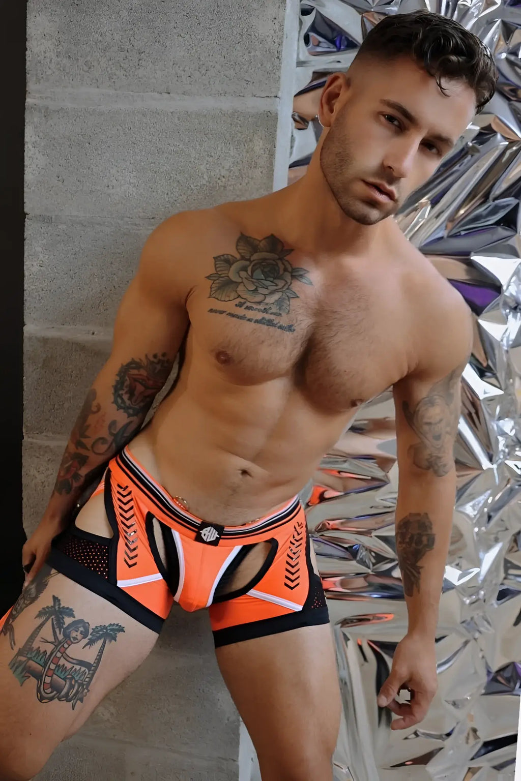 Orange and black athletic-style briefs with white trim and a central logo on the waistband called Circuit Breaker Chock