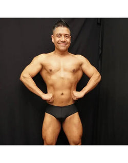 Black bodybuilding posing suit by Arroyman featuring a classic cut worn by a model showcasing physique.