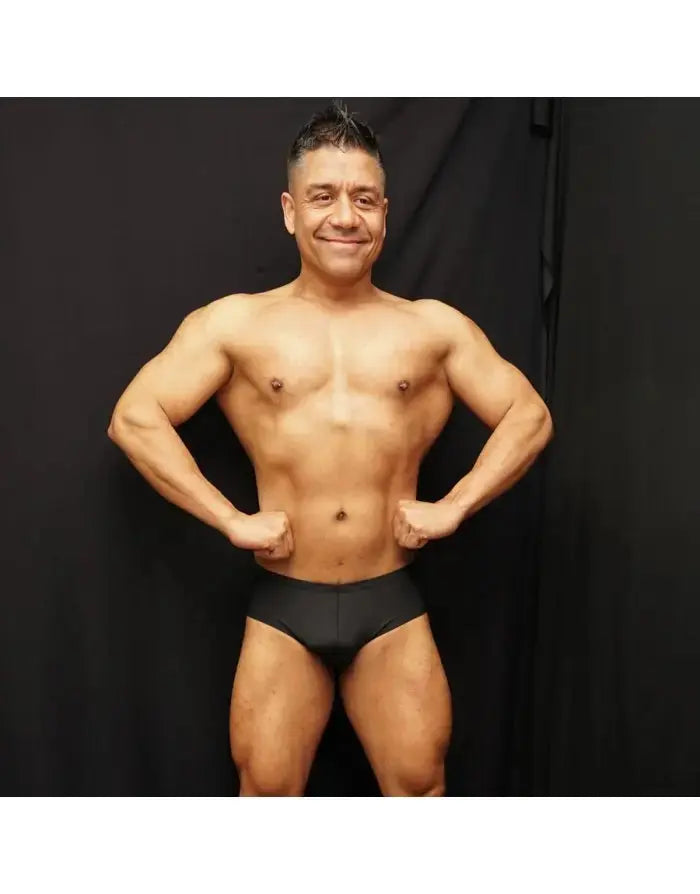 Black bodybuilding posing suit by Arroyman featuring a classic cut worn by a model showcasing physique.