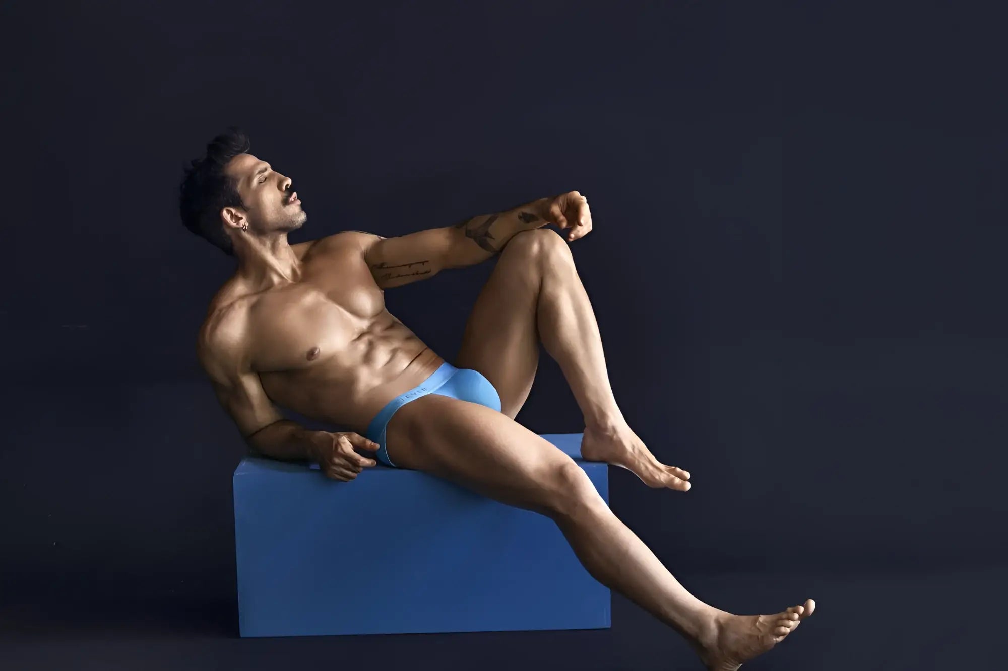 A man wearing bright blue clever 1749 eco bikini briefs made from sustainable material shown from the front