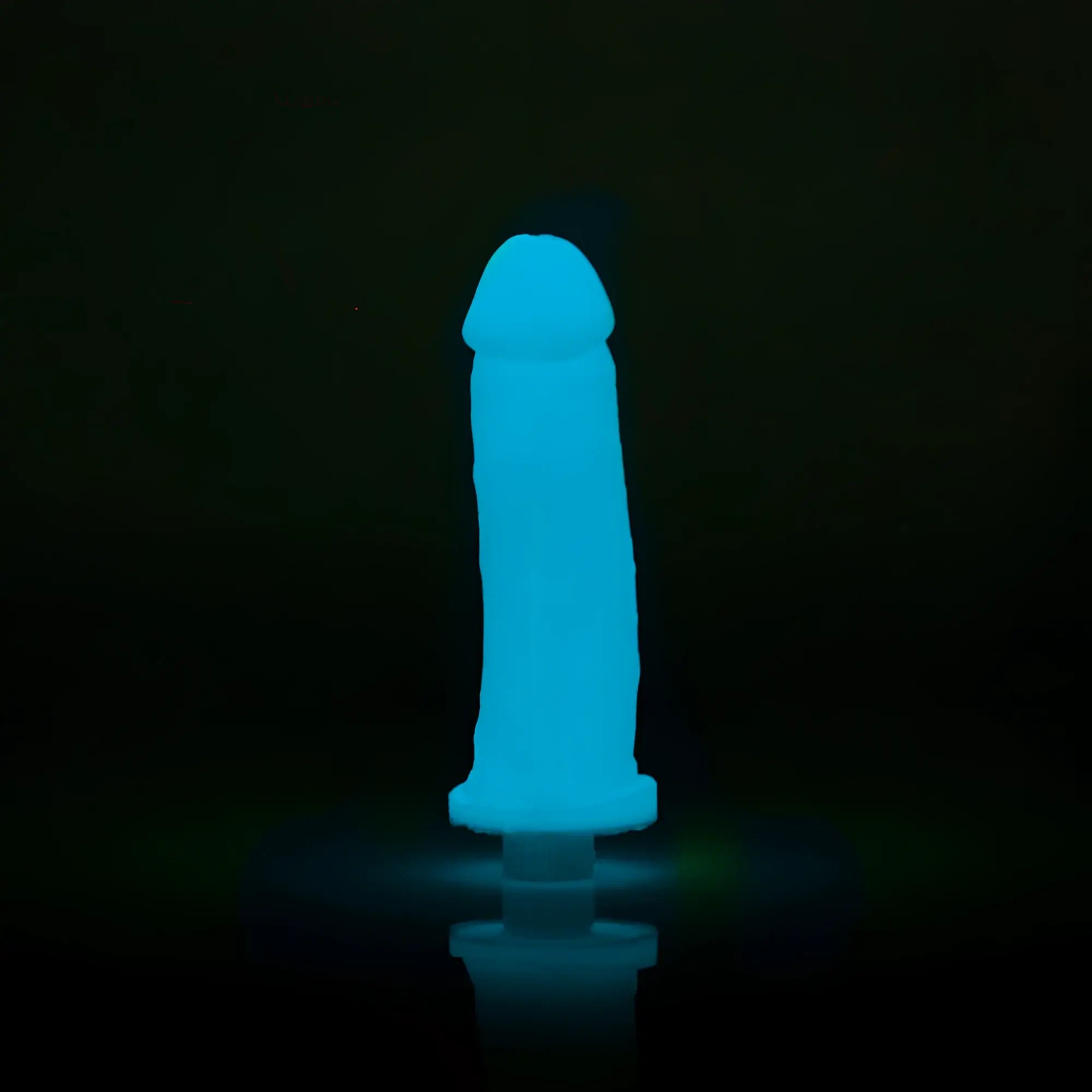 A glowing blue silicone toy clone a willy glow blue with rounded head and tapered base emitting soft light