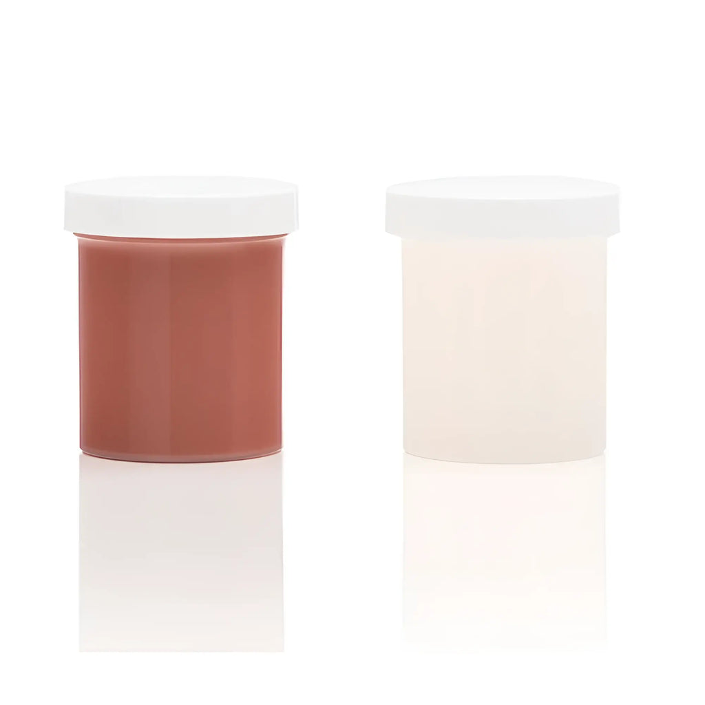 Two translucent plastic jars with silicone refill medium skin tone terracotta and cream substances in clone a willy kit