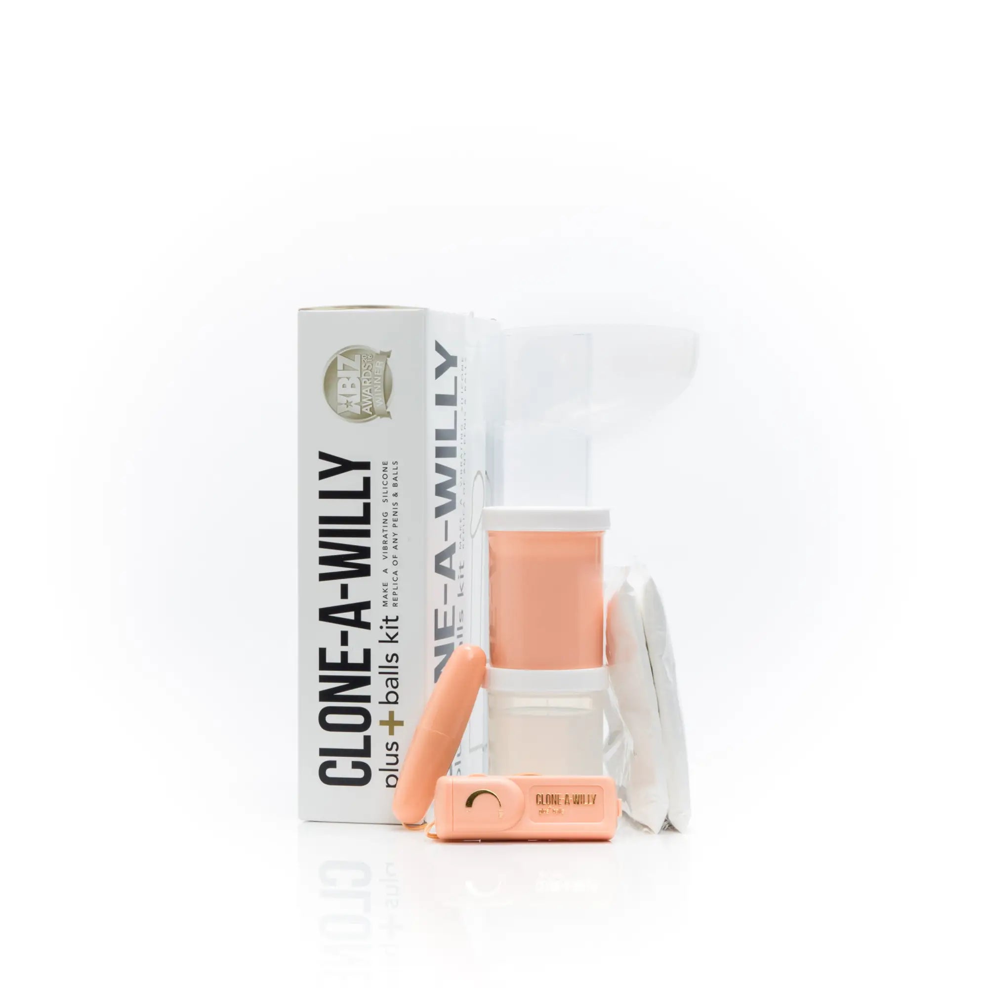 A peach-colored clone a willy plus balls kit with a white container and matching silicone components light skin tone