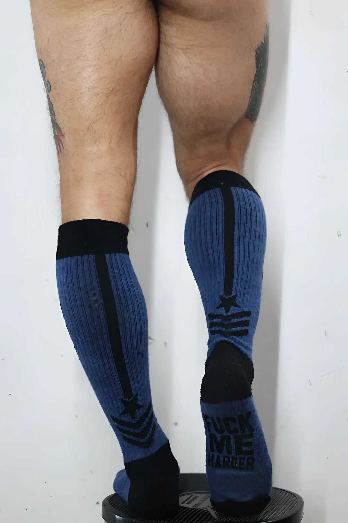 Blue ribbed knee-high cockpit socks with black accents star and stripe insignia and text on the heel back view