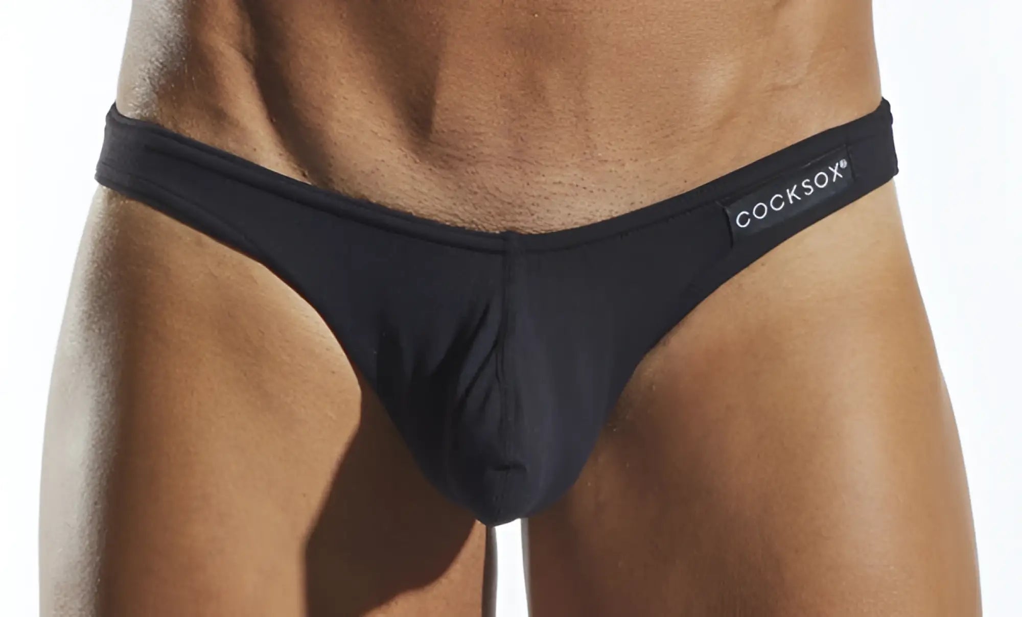 Black cocksox cx01 brief men’s thong with sleek form-fitting design and subtle logo on waistband front view