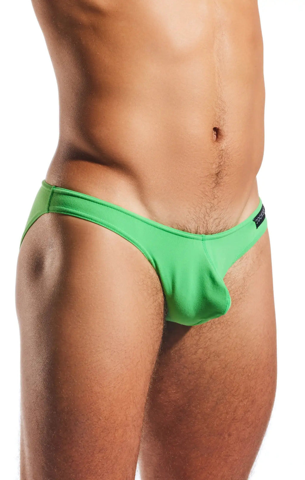 Bright green cocksox cx01 brief swim trunks with form-fitting cut and elastic waistband displayed from the front