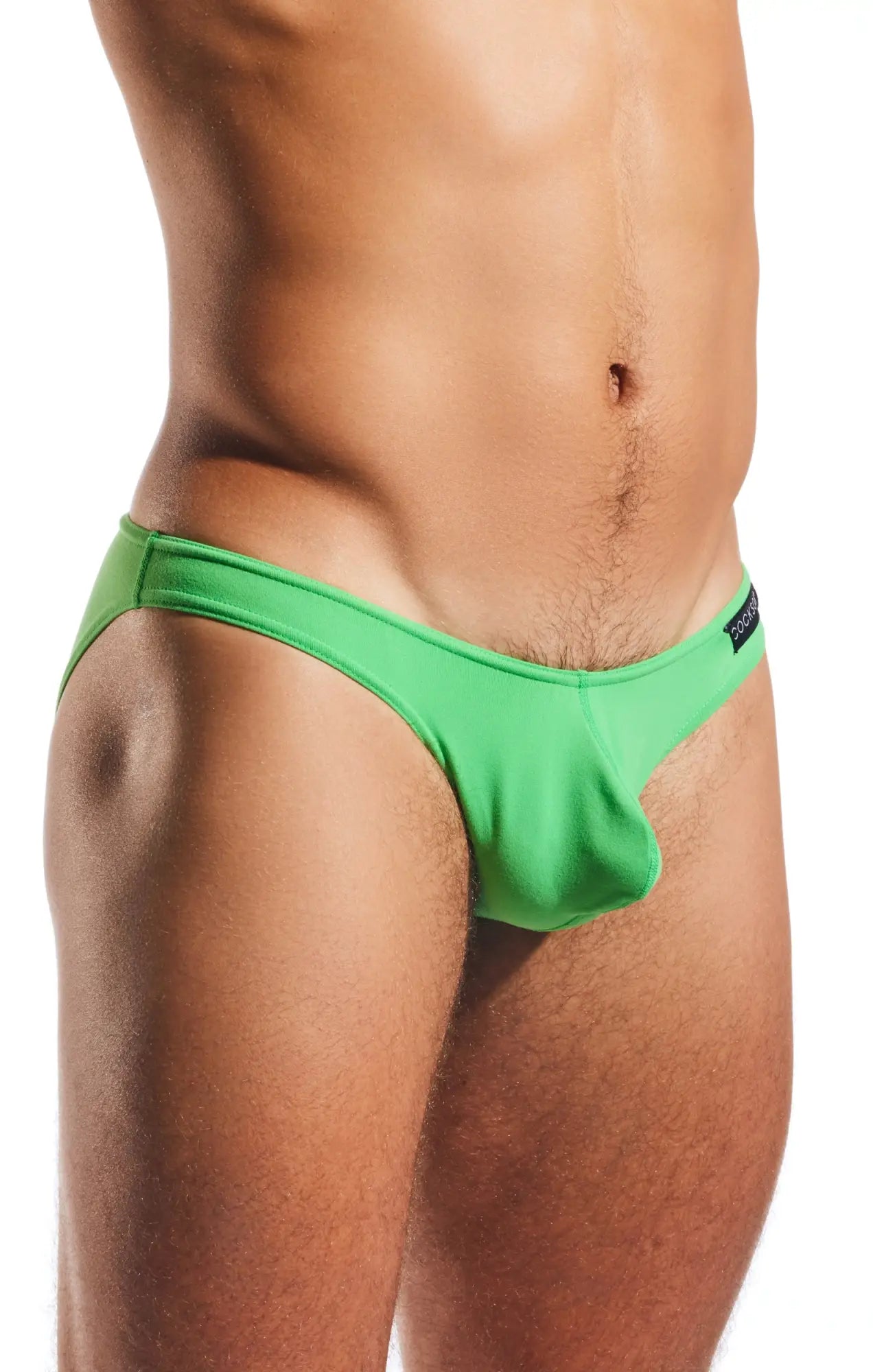 Bright green cocksox cx01 brief swim trunks with form-fitting cut and elastic waistband displayed from the front