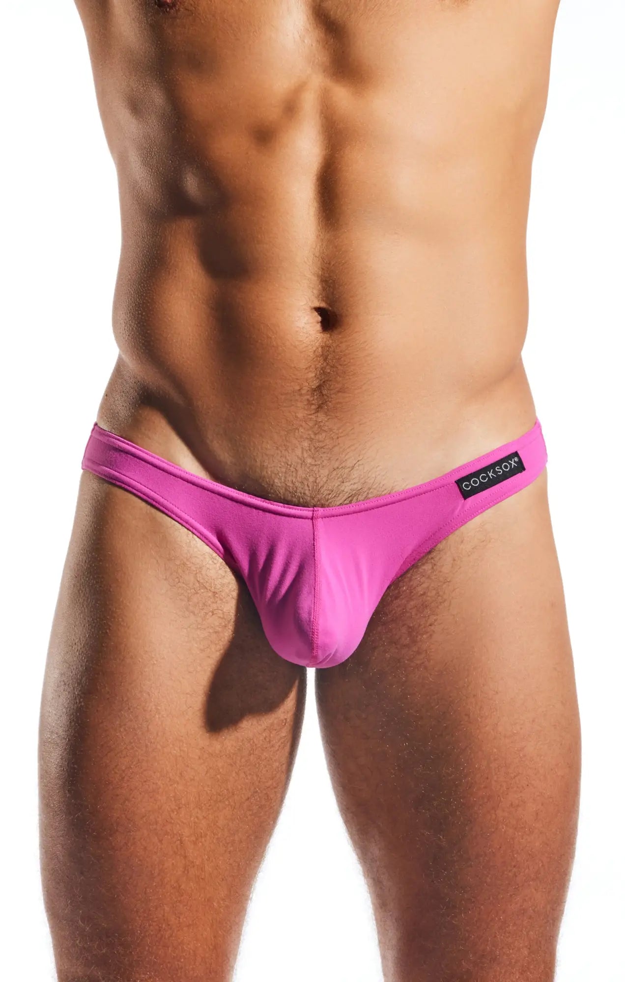 Bright pink form-fitting thong brief with black cookfox waistband label from cocksox cx01 collection