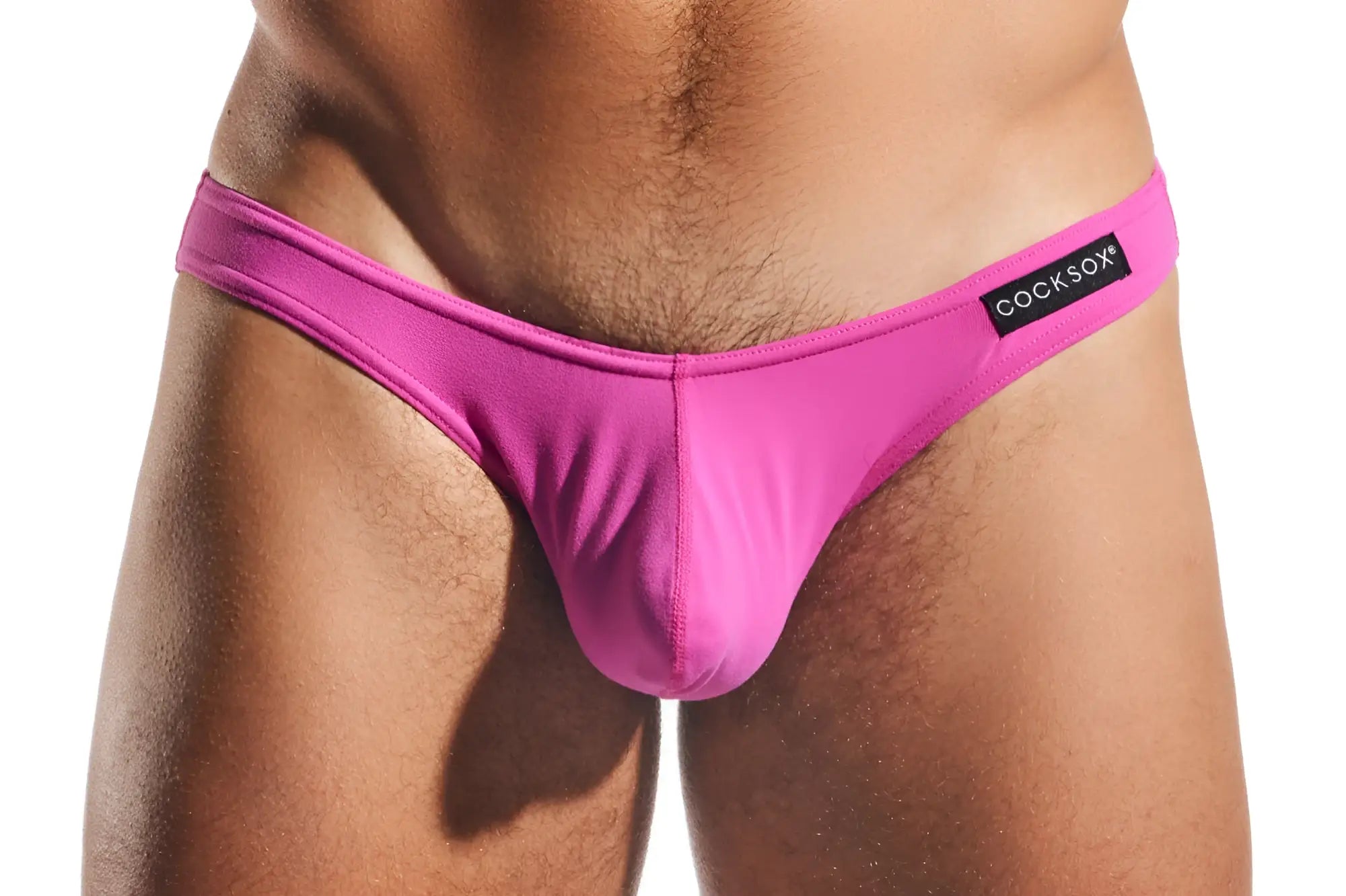 Bright pink cocksox cx01 thong made of smooth stretchy fabric with sleek design and brand label on waistband