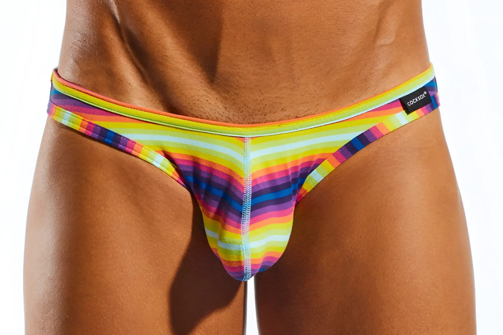 Cocksox cx01bd brief rainbow-striped men’s thong in stretchy fabric with bold neon diagonal pattern and cockade waistband label