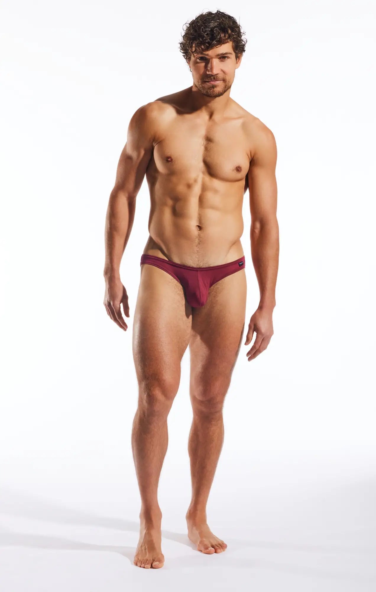 A maroon form-fitting brief made of smooth fabric with a minimalistic design by Cocksox CX01MD