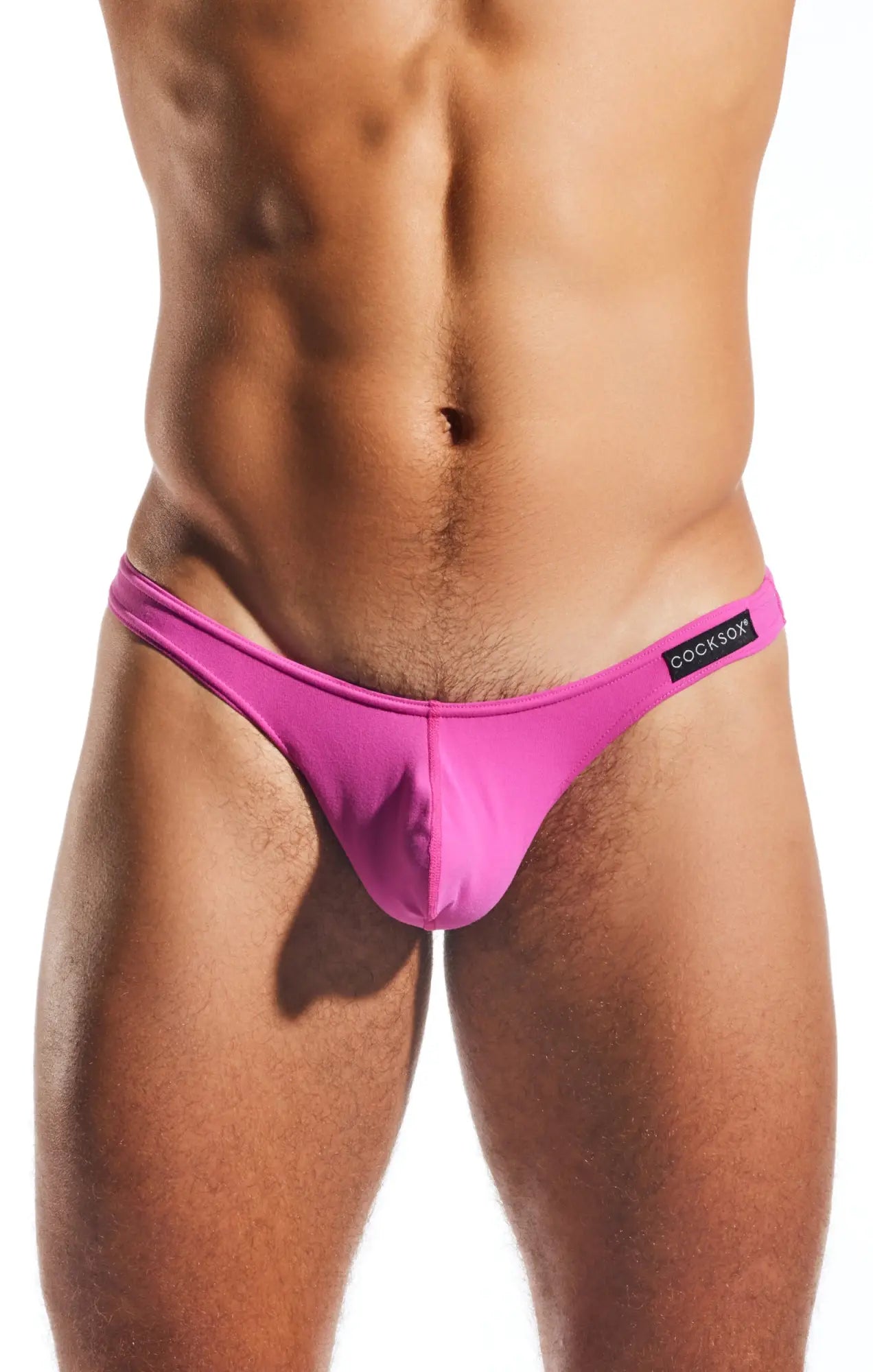 Bright pink cocksox cx05 thong men’s briefs with sleek form-fitting design and black brand tag on waistband