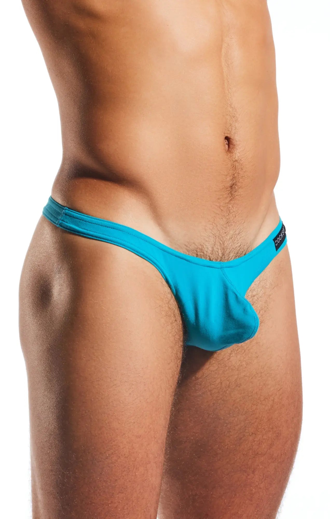 Bright turquoise cocksox cx05 thong with smooth stretchy fabric and a small black brand tag on the side