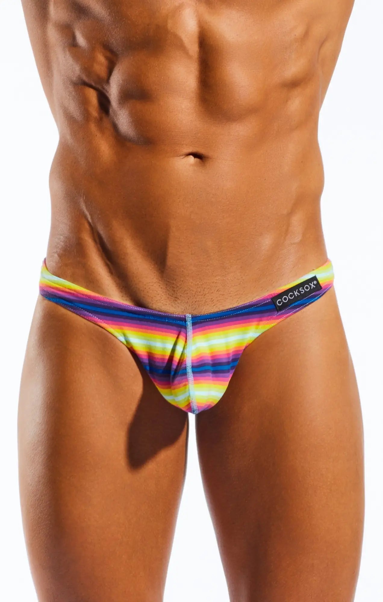 Rainbow-striped men’s thong in stretchy form-fitting fabric with cocksox logo on waistband front view