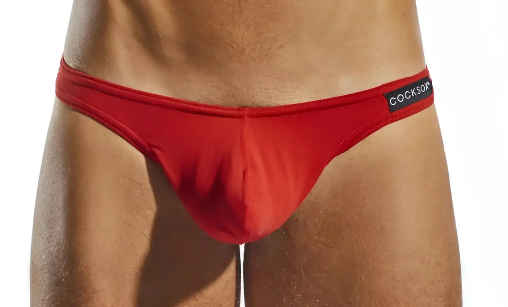 Red Cocksox CX05 thong briefs with smooth form-fitting fabric and a black waistband label visible from the front