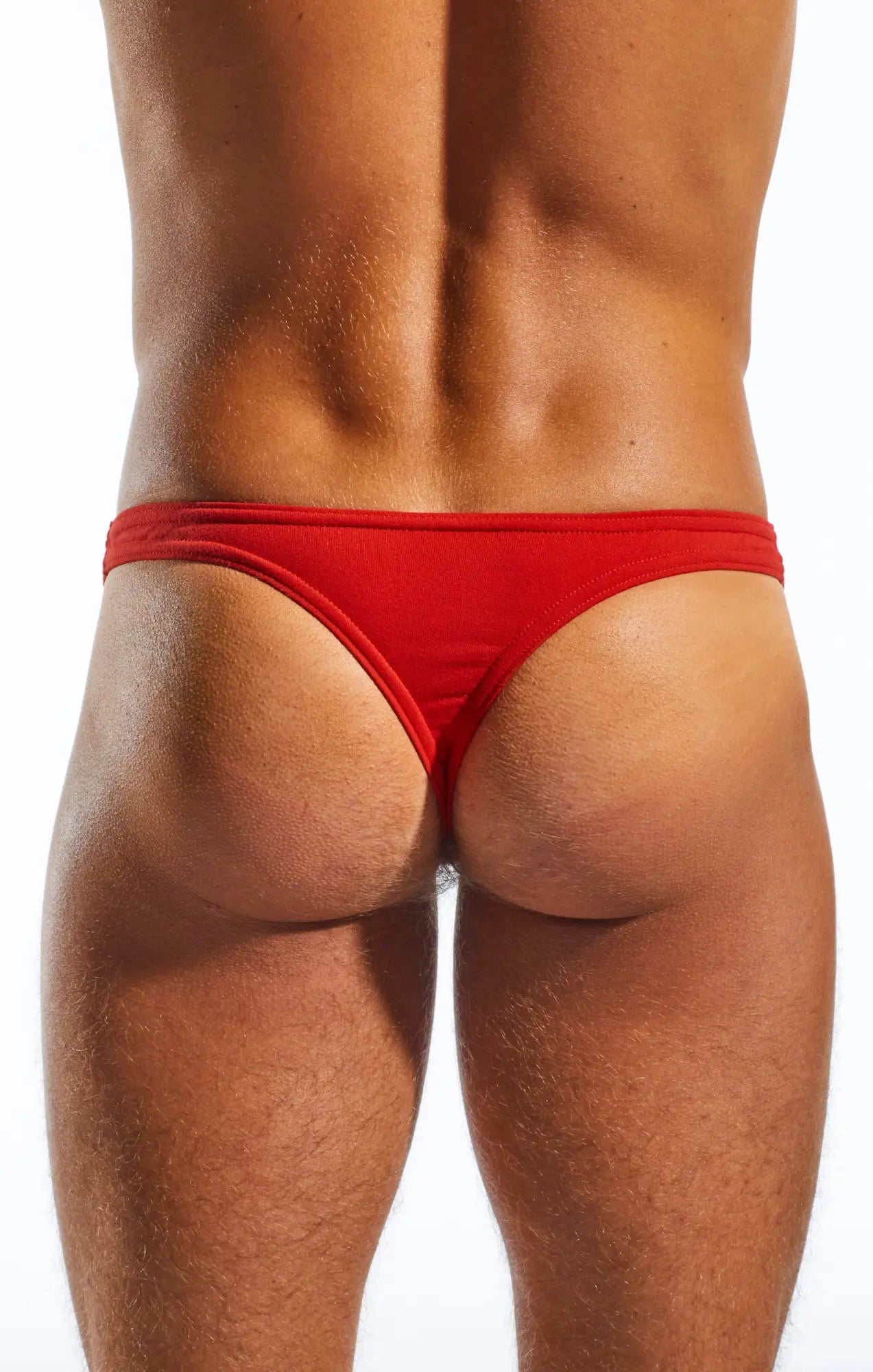 Red form-fitting Cocksox CX05 thong made of smooth fabric showing the back side of the underwear