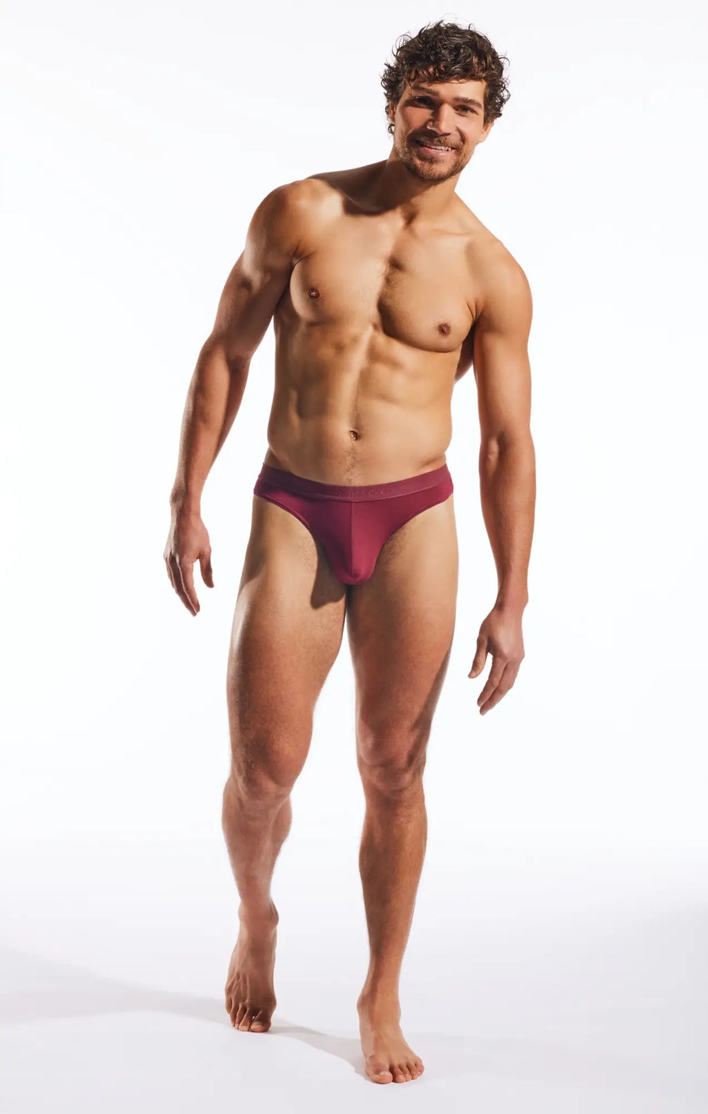 Cocksox CX05MD thong maroon form-fitting briefs with smooth fabric and minimalistic design shown from the back side