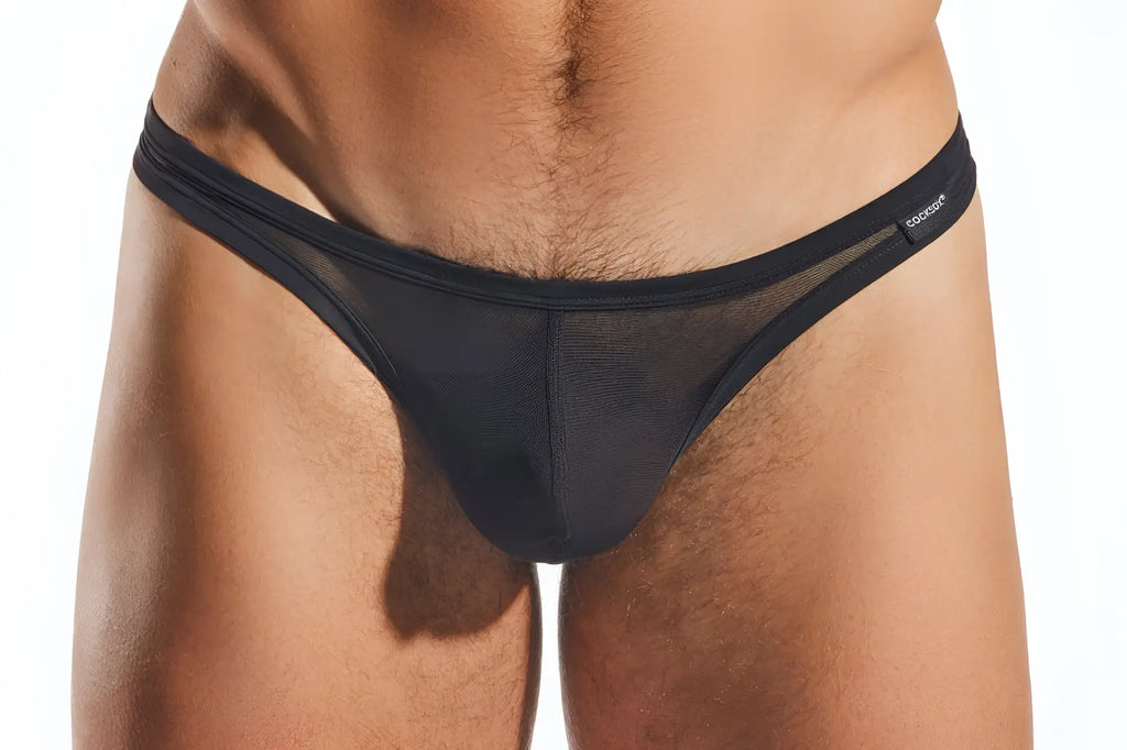 Black mesh thong with solid elastic waistband featuring cocksuit brand label on the side cocksox cx05me mesh thong
