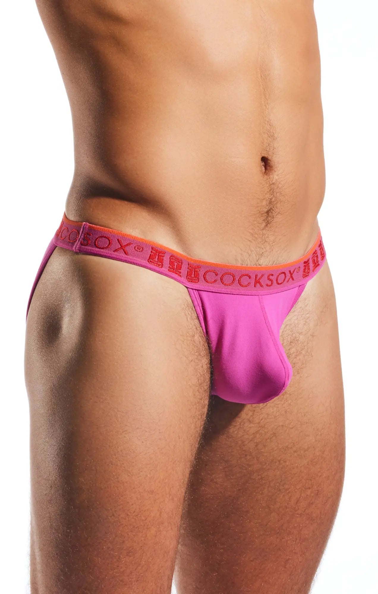 Bright pink cocksox cx16n bikini brief with orange waistband featuring repeating brand name lettering