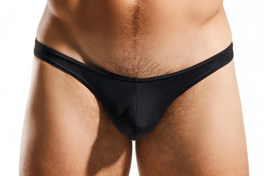 Black sleek form-fitting thong made of smooth fabric by Cocksox CX22 swim thong shown from the back side