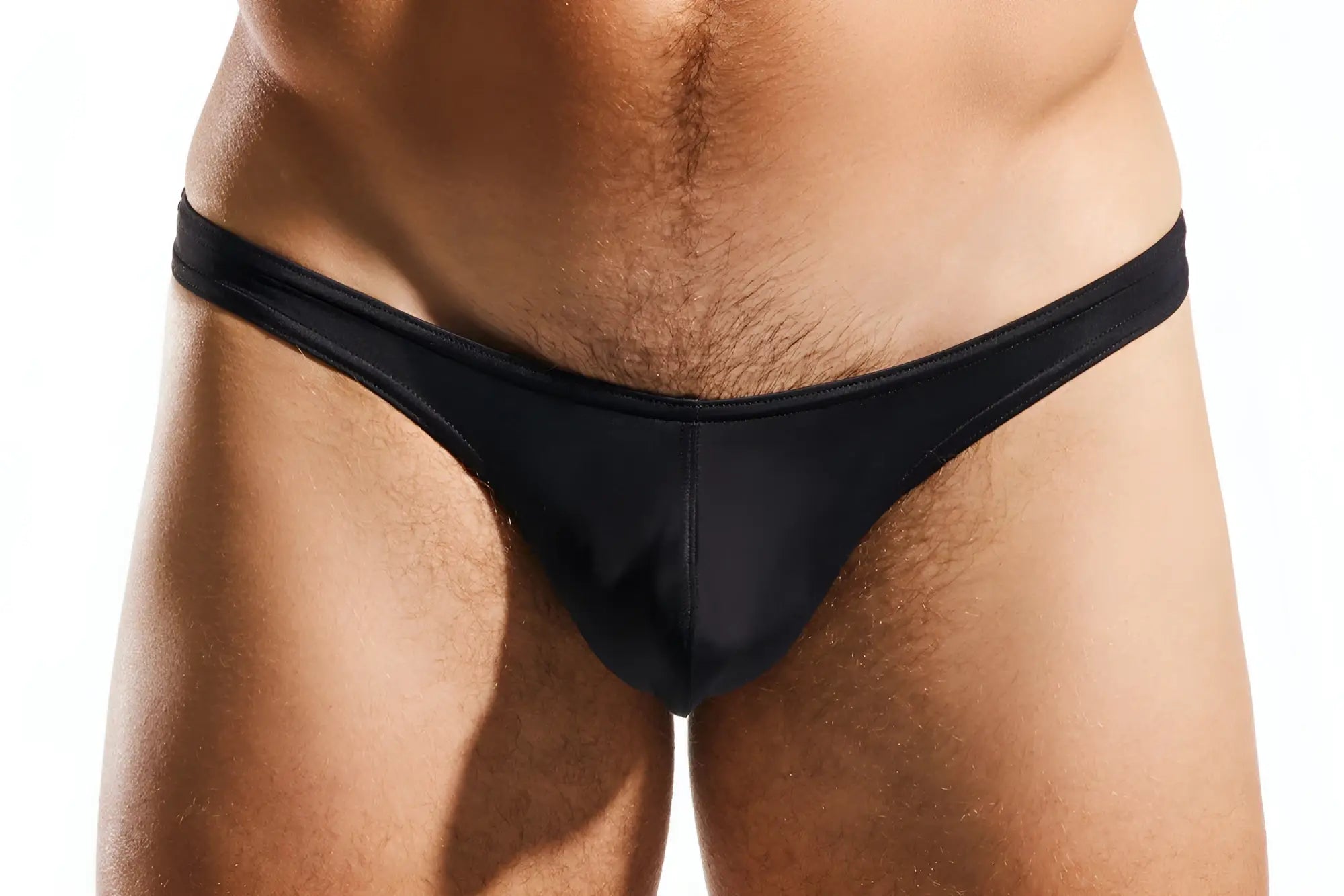 Black sleek form-fitting thong made of smooth fabric by Cocksox CX22 swim thong shown from the back side