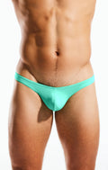 A sleek turquoise cocksox cx22 swim thong made of smooth stretchy fabric designed for swimming and beachwear
