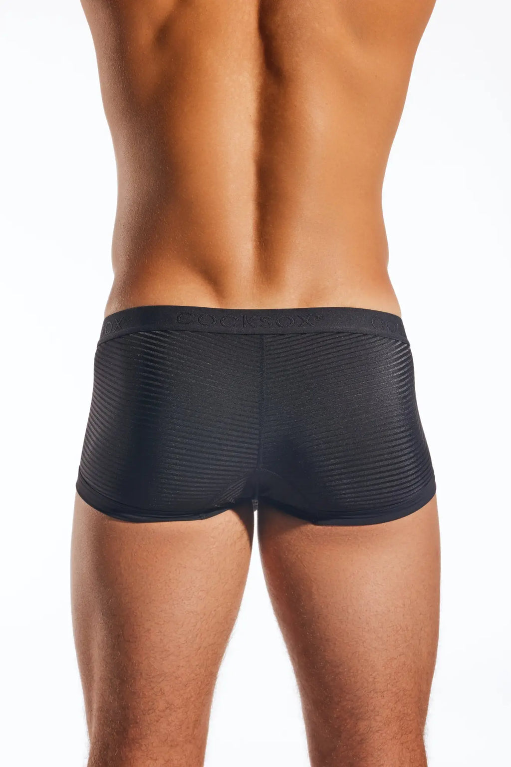 Black cocksox cx68lux semi-sheer trunk briefs with subtle ribbed texture and branded waistband in front view