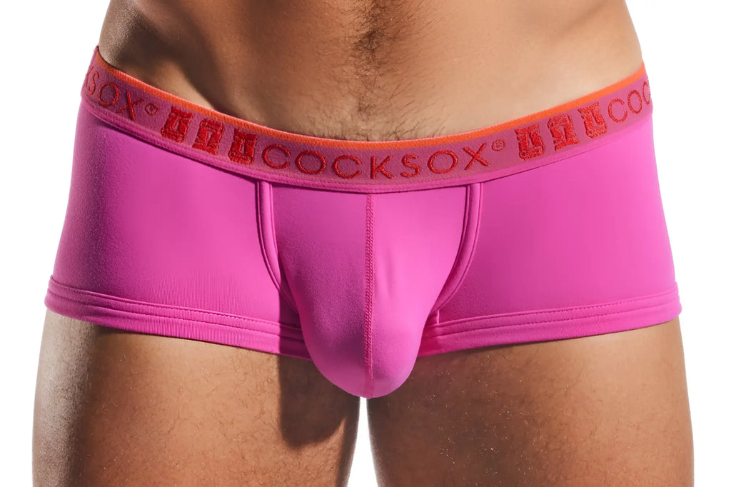 Bright pink form-fitting men’s briefs with an orange waistband and red anuccocksox logo cocksox cx68n trunk