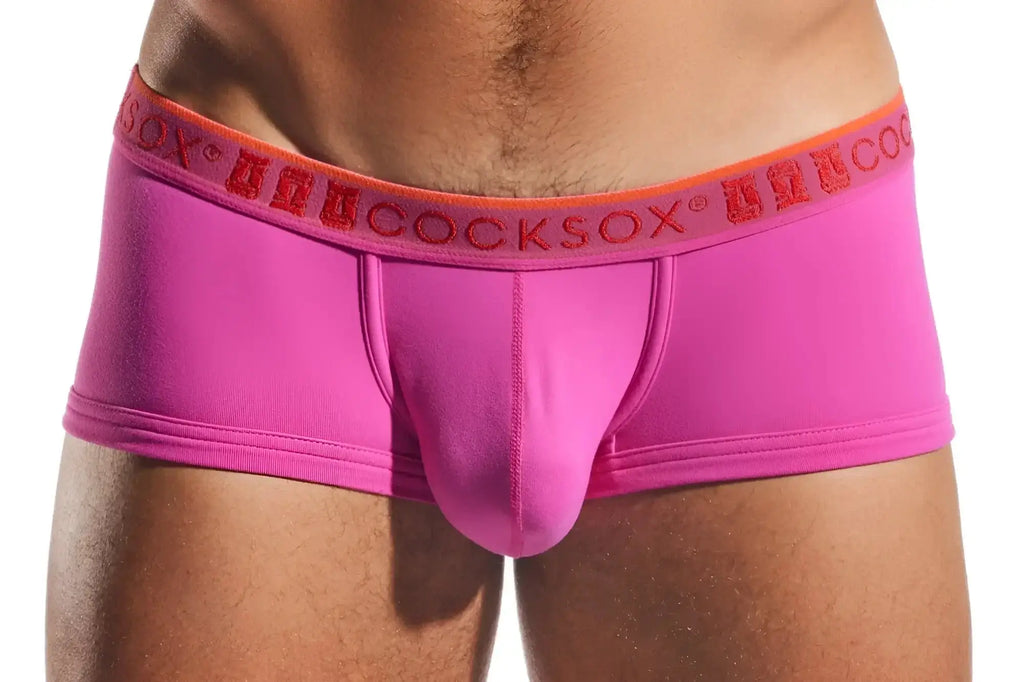 Bright pink form-fitting men’s briefs with an orange waistband and red anuccocksox logo cocksox cx68n trunk