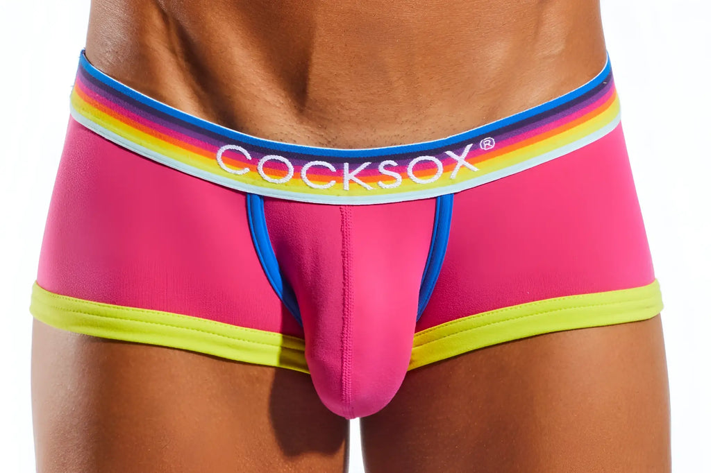 Bright pink cocksox cx68n trunk briefs with rainbow-striped waistband and neon yellow trim for men