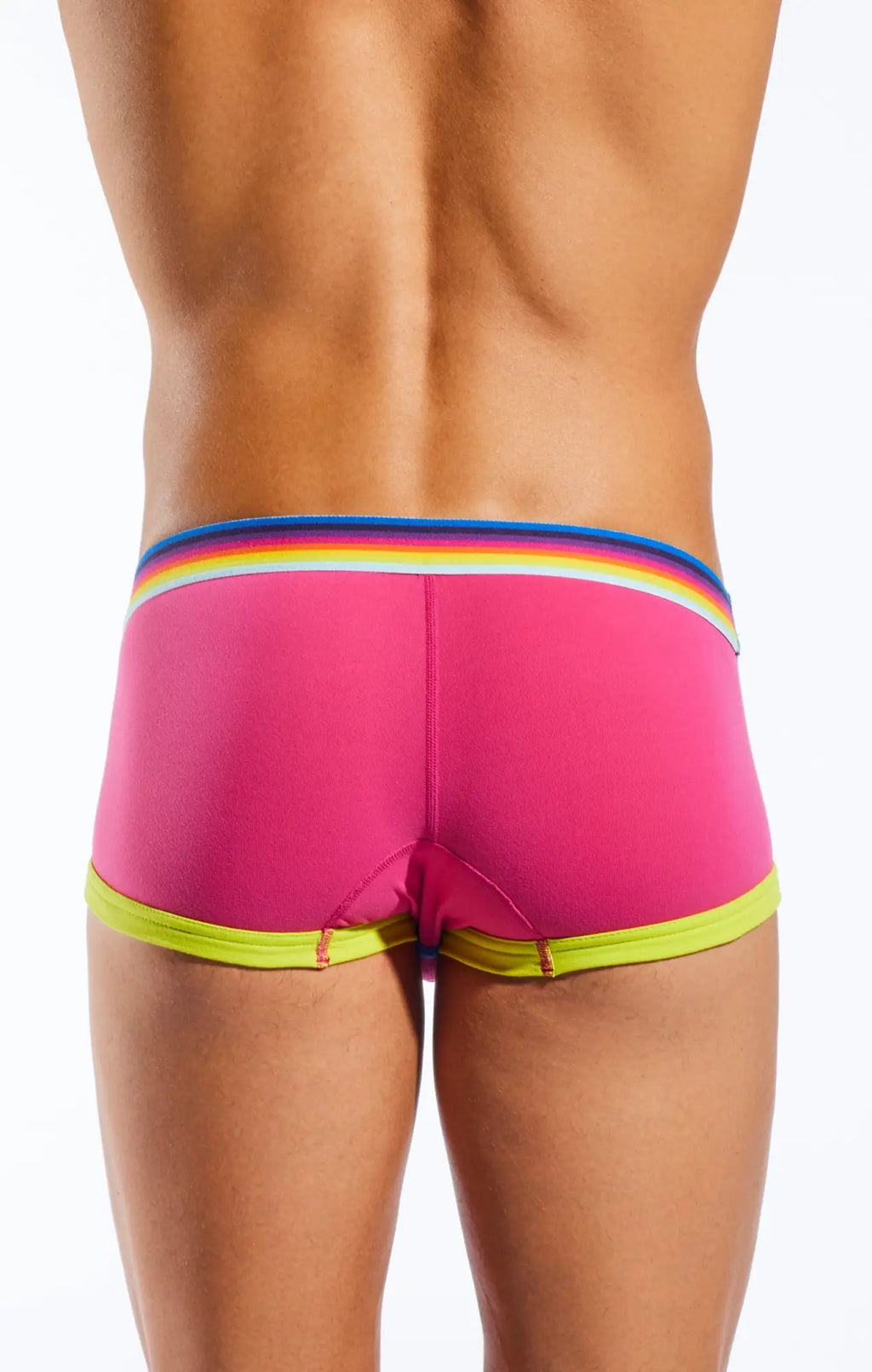 Bright pink Cocksox CX68N swim trunks with rainbow-striped waistband and neon yellow trim for beachwear