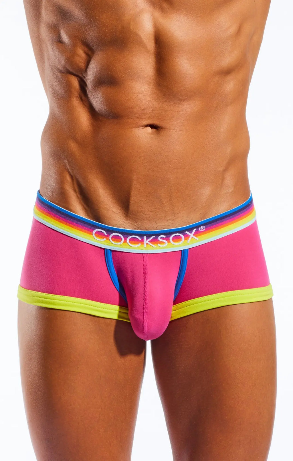 Vibrant pink cocksox cx68n trunk briefs with neon yellow trim and rainbow-striped elastic waistband