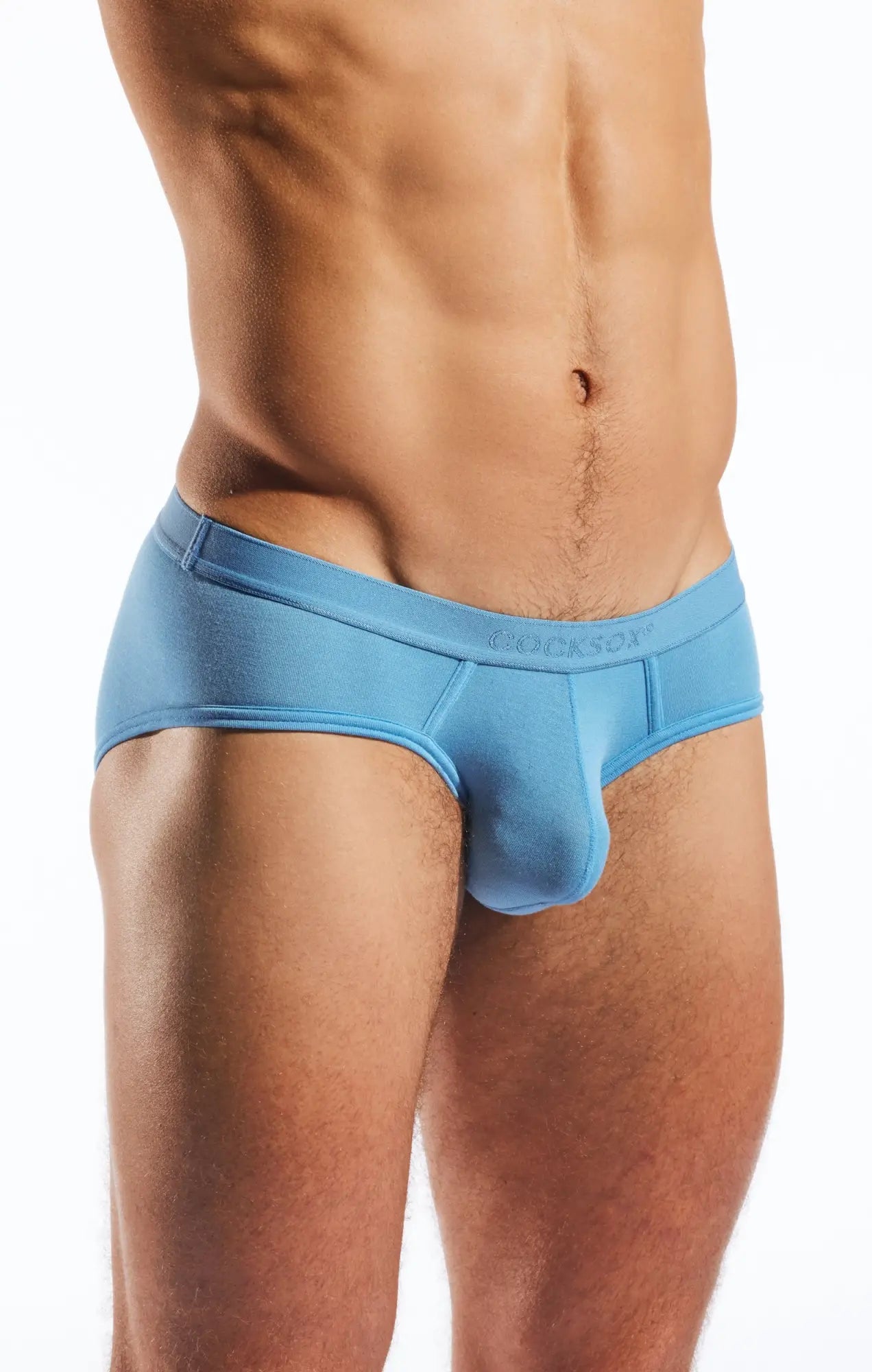 Light blue form-fitting cocksox cx76md sports briefs with smooth fabric and cragasox embroidered waistband