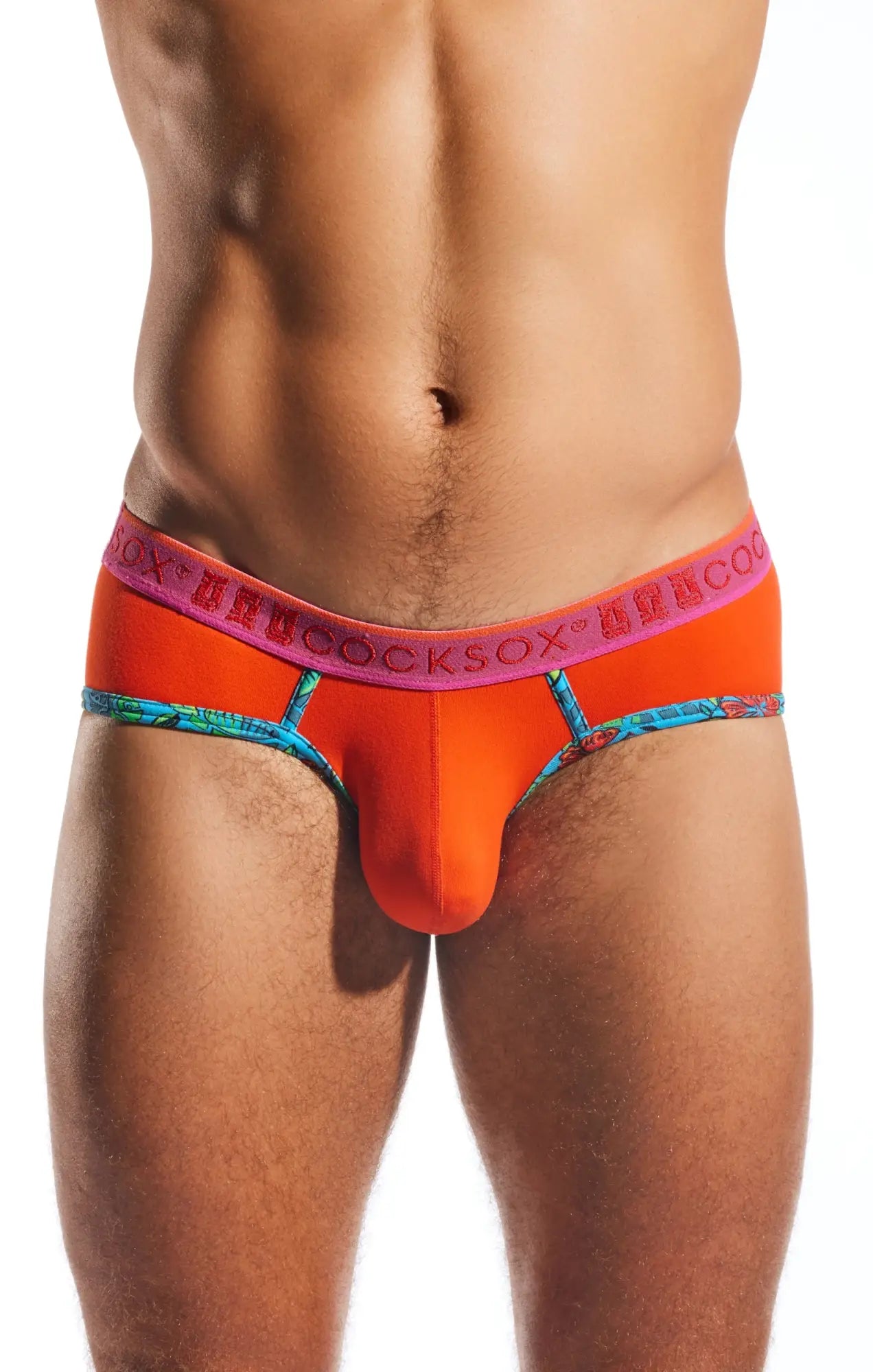 Bright orange cocksox cx76n sports brief with pink waistband logo and blue patterned trim for men