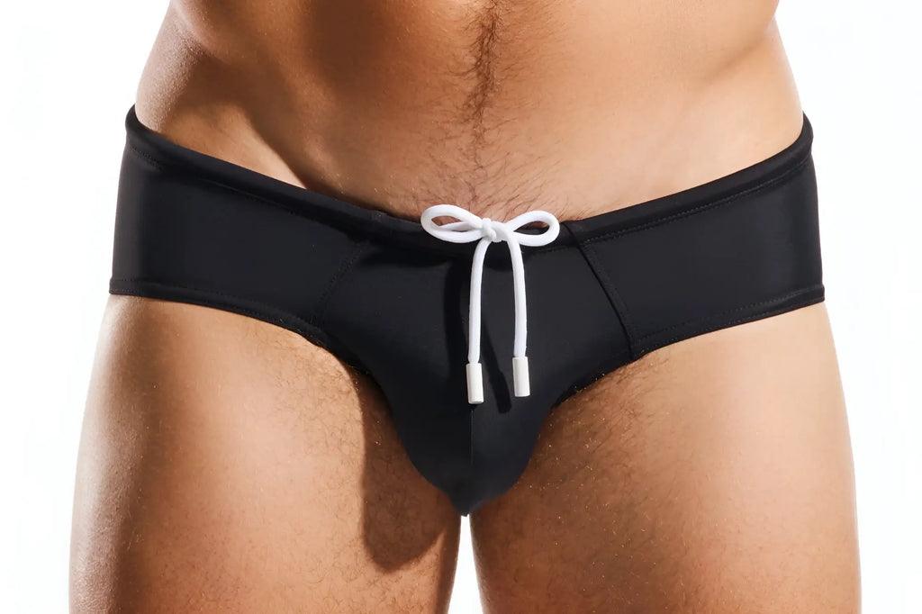 Black cocksox cx79 boy leg swim brief with white drawstring bow at the waist designed for swimming and beachwear