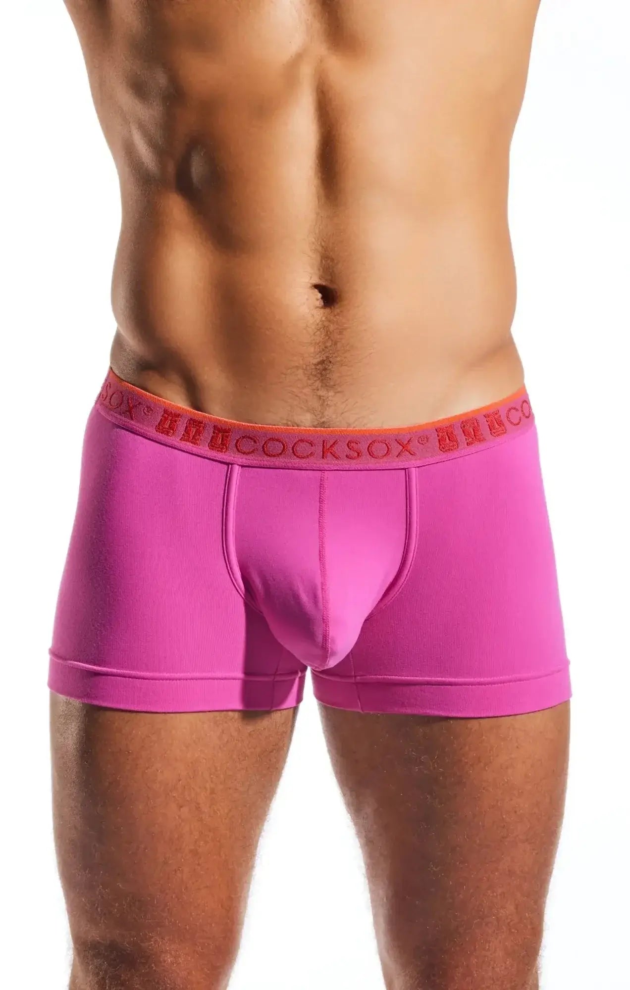 Bright pink cocksox cx94 men’s boxer briefs with orange waistband and hercosox red brand lettering