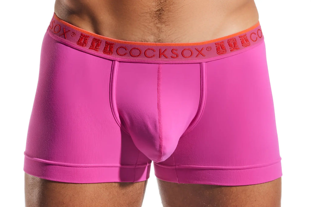 Bright pink cocksox cx94 men’s boxer briefs with orange waistband and red brand name lettering