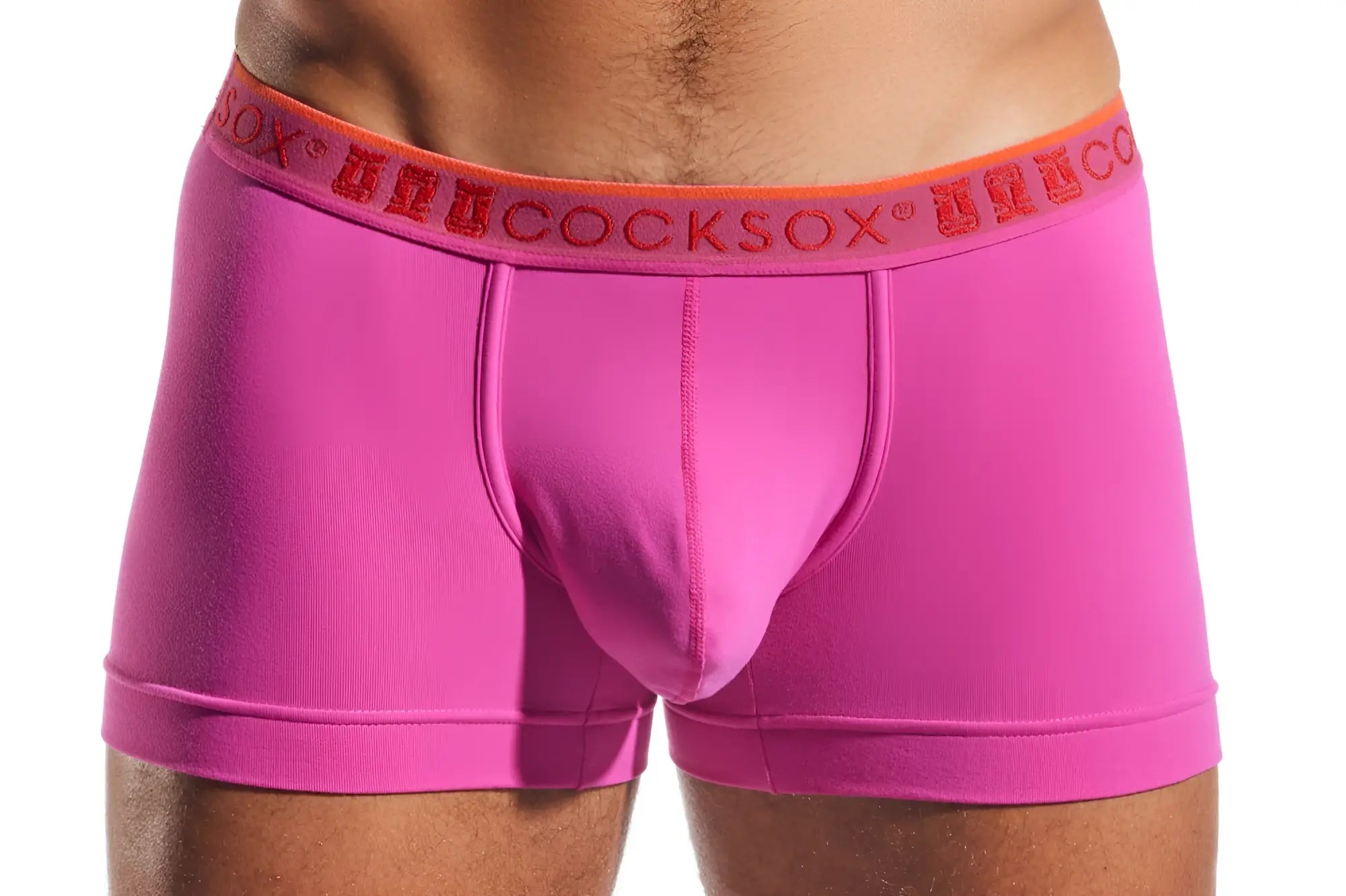 Bright pink cocksox cx94 men’s boxer briefs with orange waistband and red brand name lettering