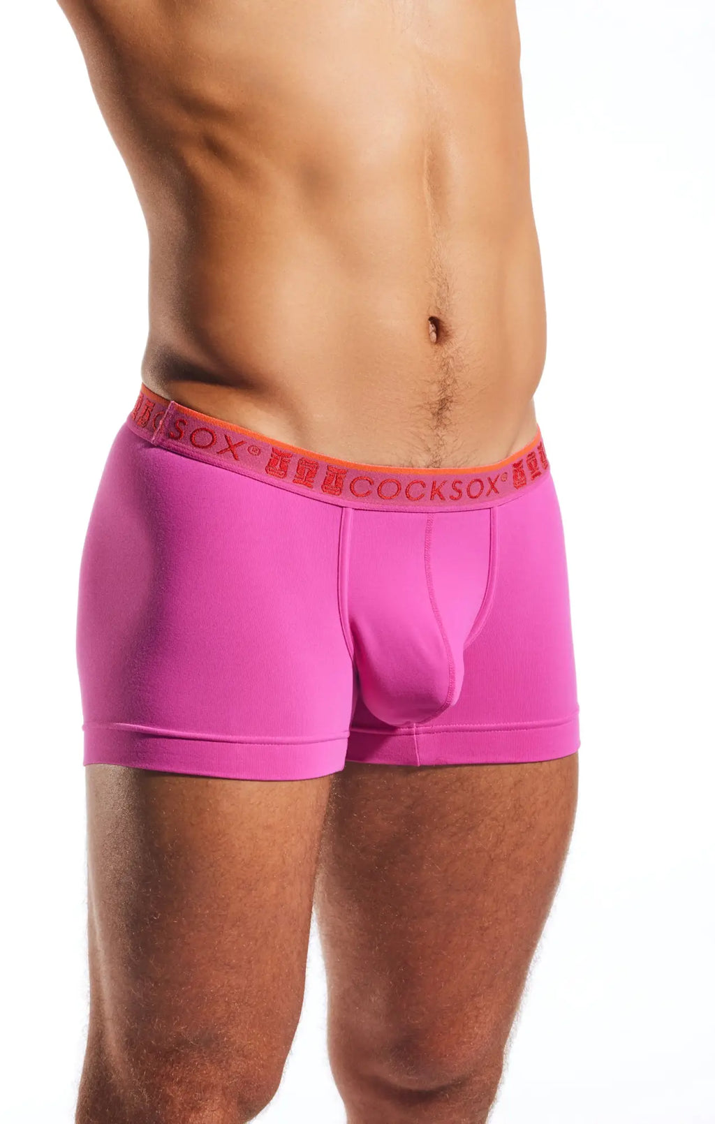 Bright pink cocksox cx94 boxer brief with orange waistband featuring repeated cocksox brand name lettering