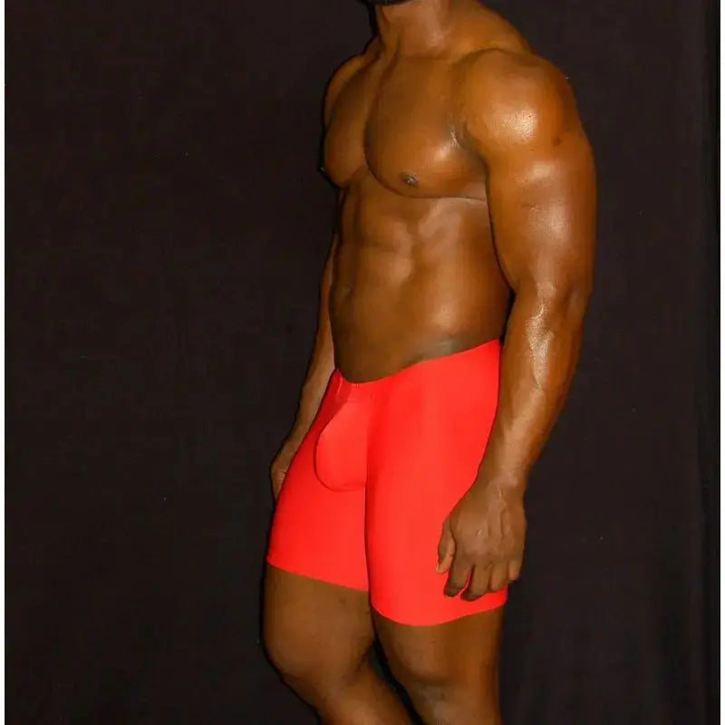 Red compression shorts made of stretchy material shown on a model designed for comfort and support by Arroyman.
