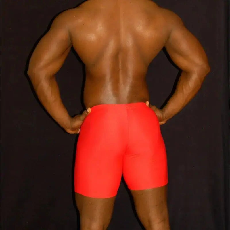Red compression shorts made of stretchy material shown from the back on a model by Arroyman.