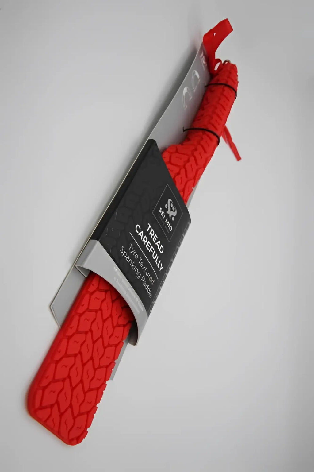 CreativeC Tyre Paddle large red rubber tire-spreading paddle with textured tread pattern in black and silver packaging