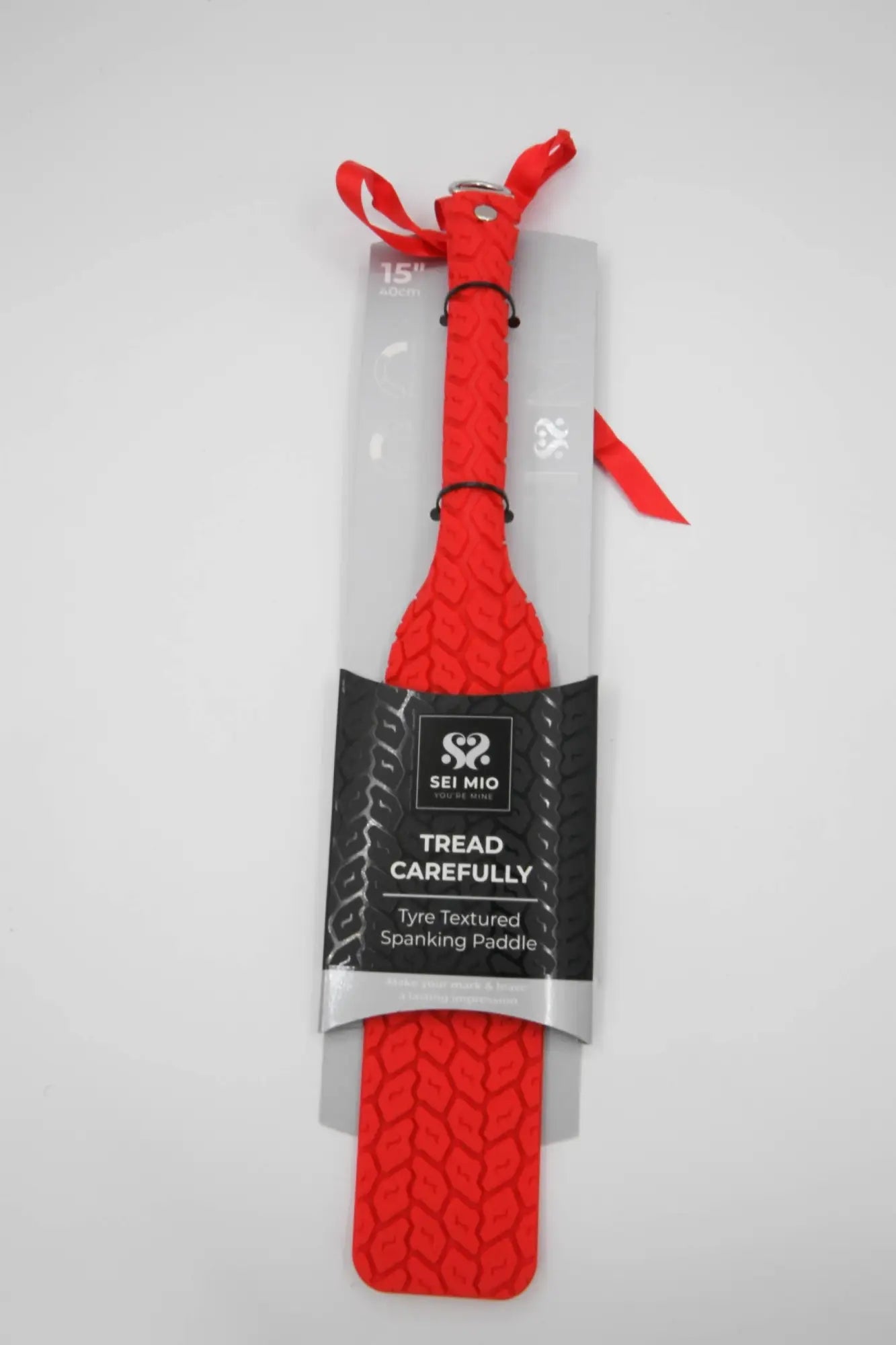 CreativeC tyre paddle large red is a red tyre-textured spanking paddle by sei mio packaged in clear plastic with black label and red ribbon