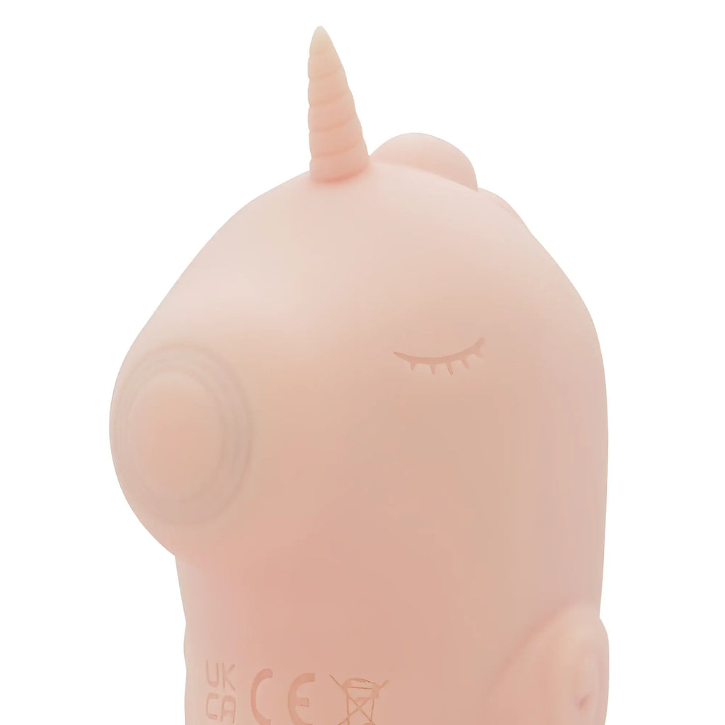 Pastel pink silicone unicorn-shaped vibrator with closed-eye design and smooth rounded body creativec unihorn massager