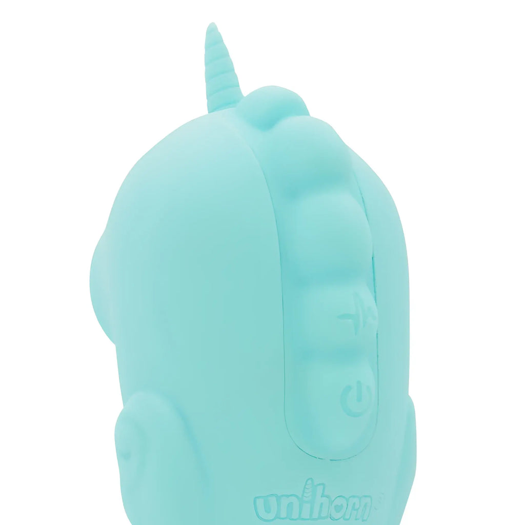A mint green silicone unicorn-shaped creativec unihorn massager with a horn and embossed buttons for ocean peak use