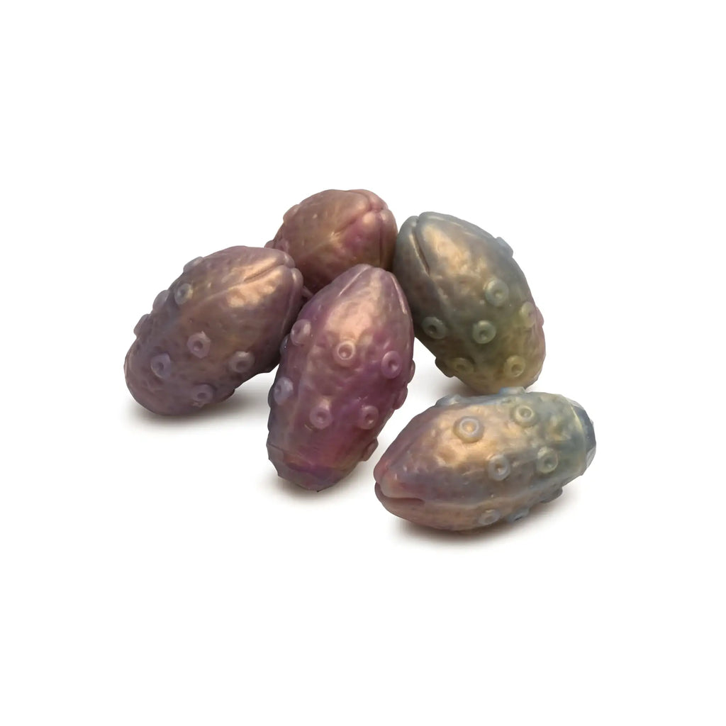 Iridescent beetle-shaped beads with a glossy purple and gold finish on a silicone deep invader tentacle ovipositor dildo