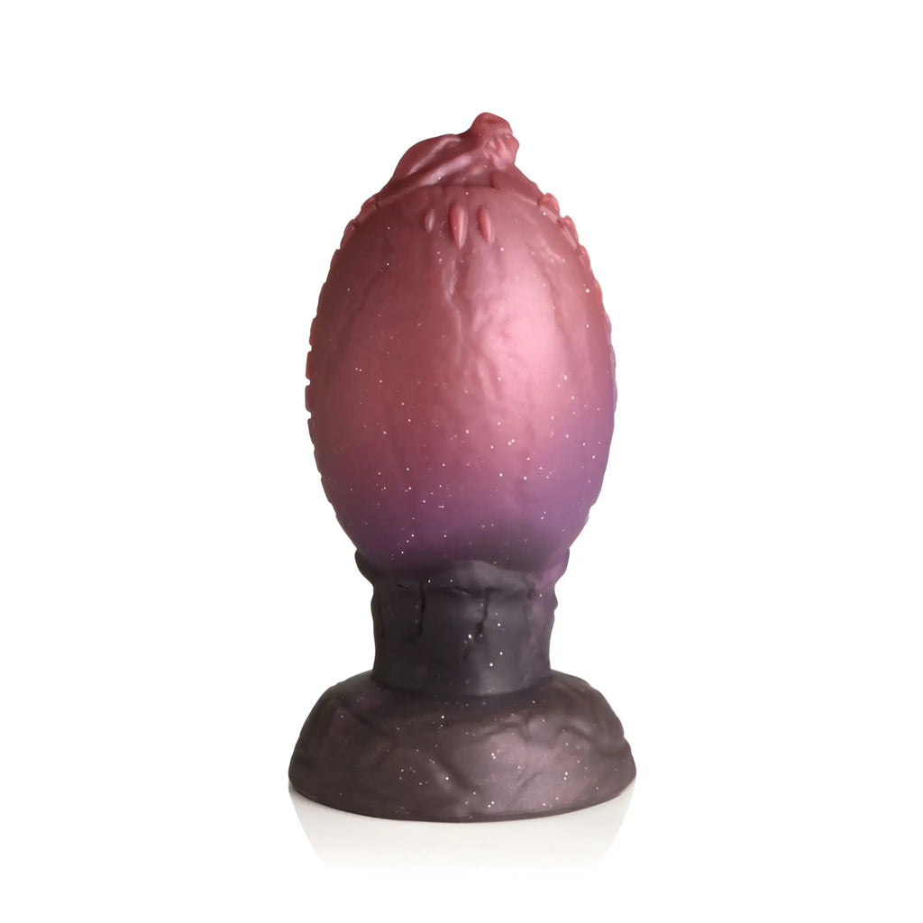 Creature cocks dragon hatch silicone egg lamp with a gradient pink to purple speckled textured surface and dark base