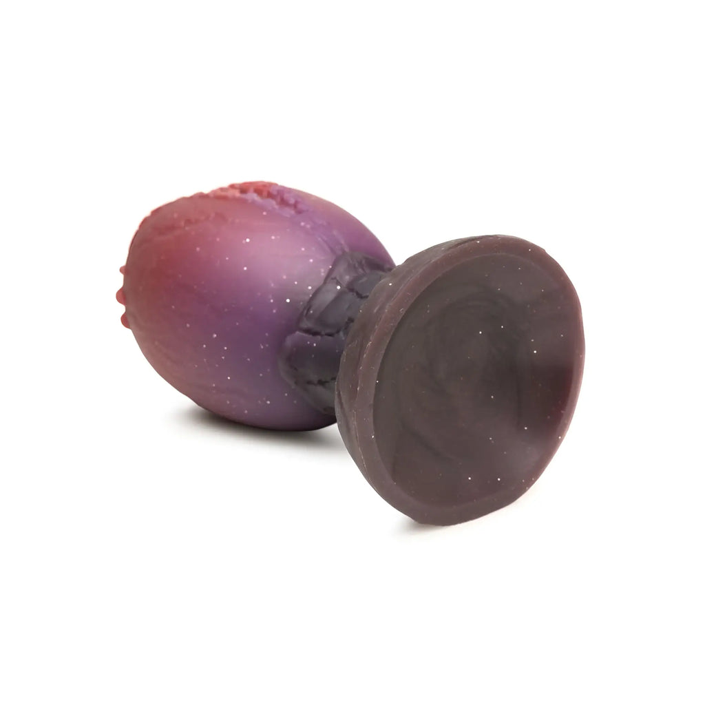 Purple and red gradient silicone anal plug with textured starry surface from creature cocks dragon hatch silicone egg