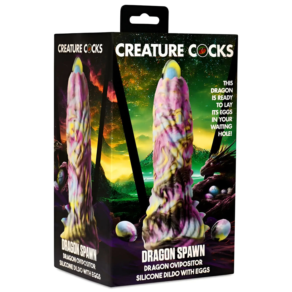 Pink and yellow dragon-shaped silicone dildo with eggs in a Creature Cocks Dragon Spawn dragon ovipositor box