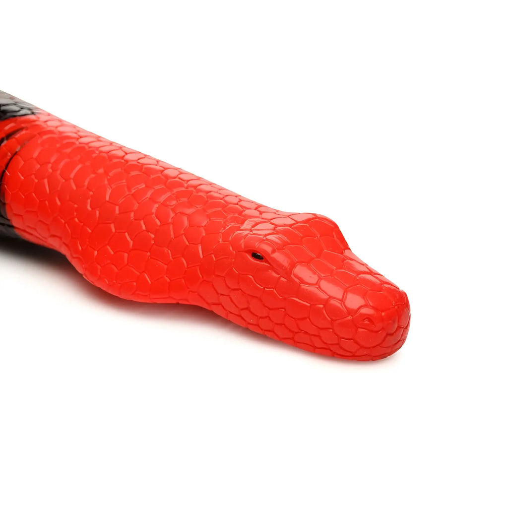 A vibrant red silicone king cobra toy with textured scales and black head markings from creature cocks large 14 inch line